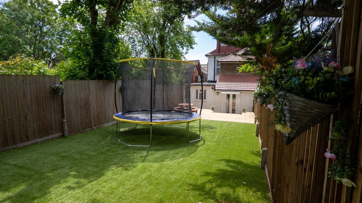 The Spruces garden with trampoline and outdoor dining area
